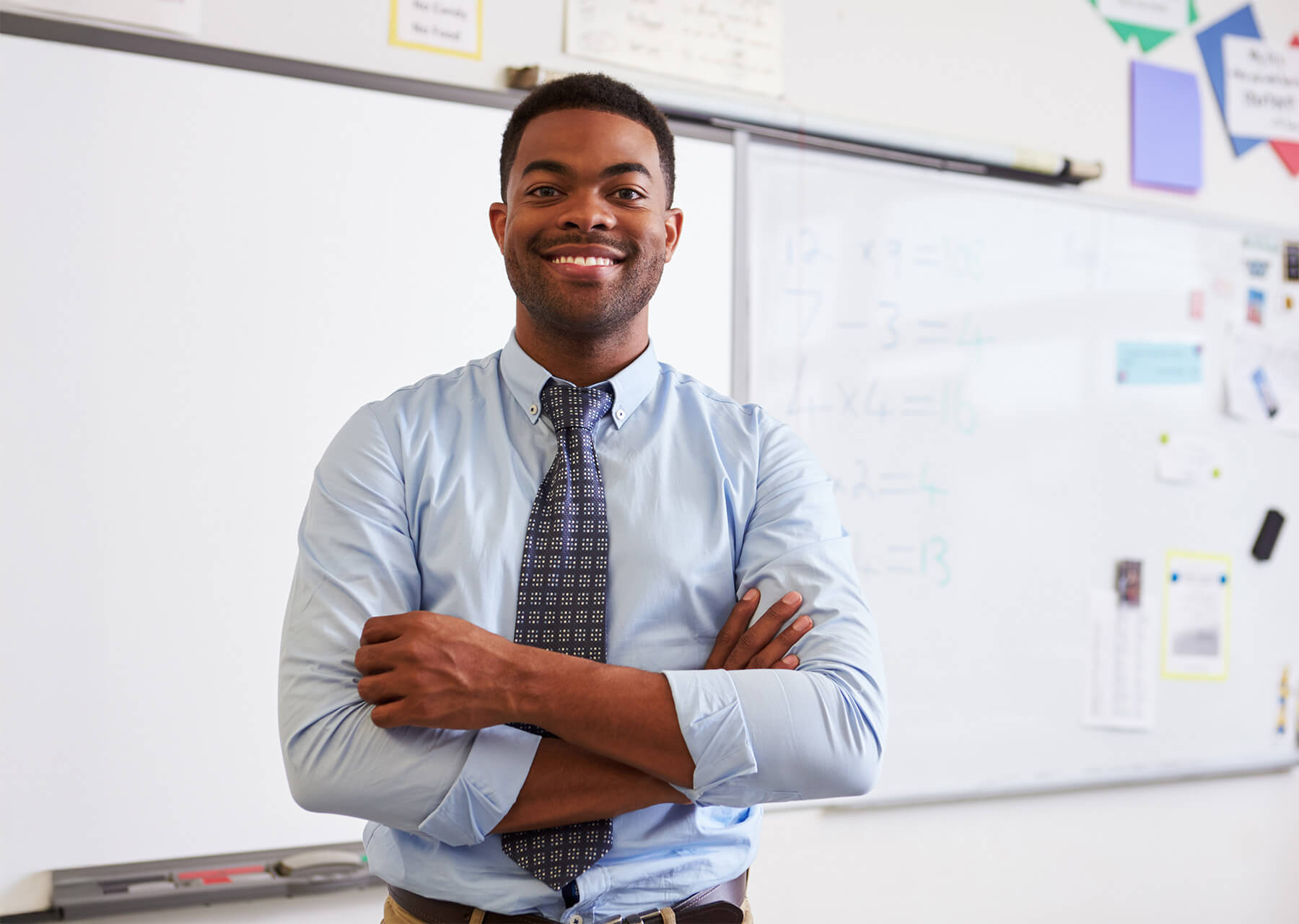Ontario teacher standing in classroom in front of white board