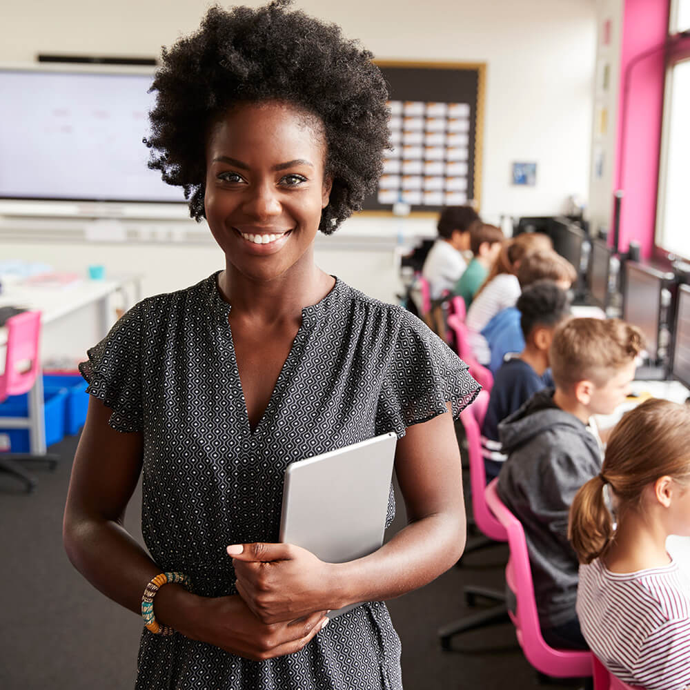 Ontario teacher standing in classroom